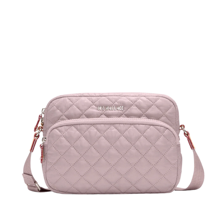 Quilted pink crossbody bag on a white background