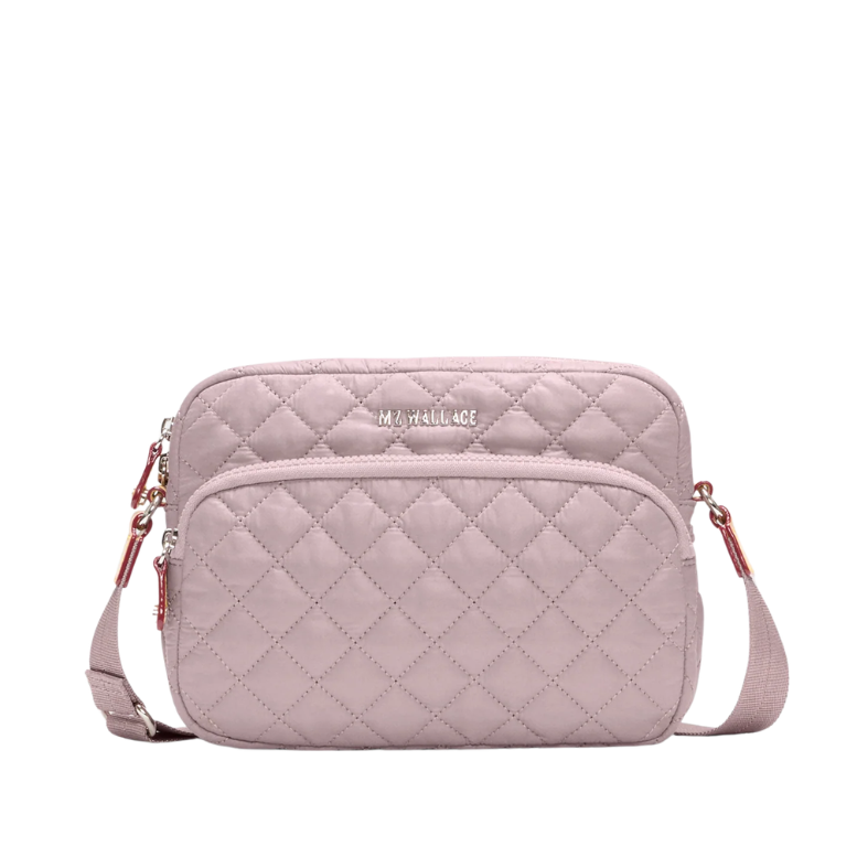 Quilted pink crossbody bag on a white background